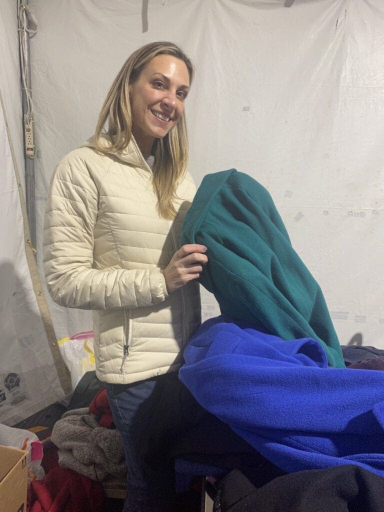 Meredith handing out winter coats to Prevention Point clients