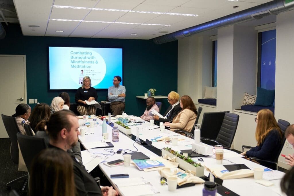 Attendees participating in “Combatting Burnout with Mindfulness & Meditation” session with Stacey Foley and Gabe Nathan.