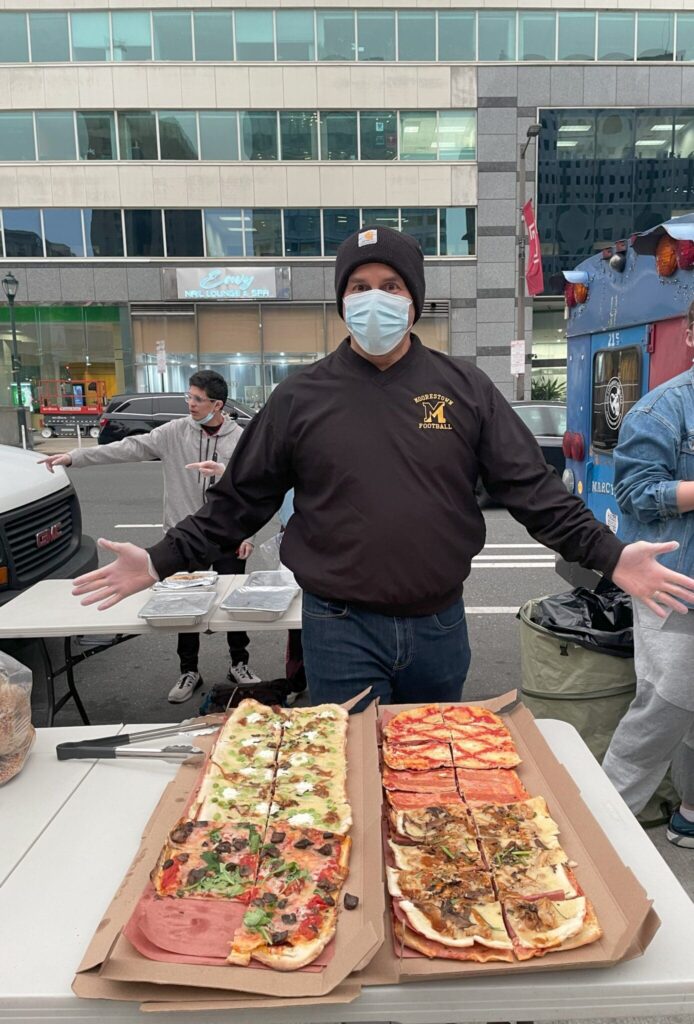 Paul getting ready to serve pizza